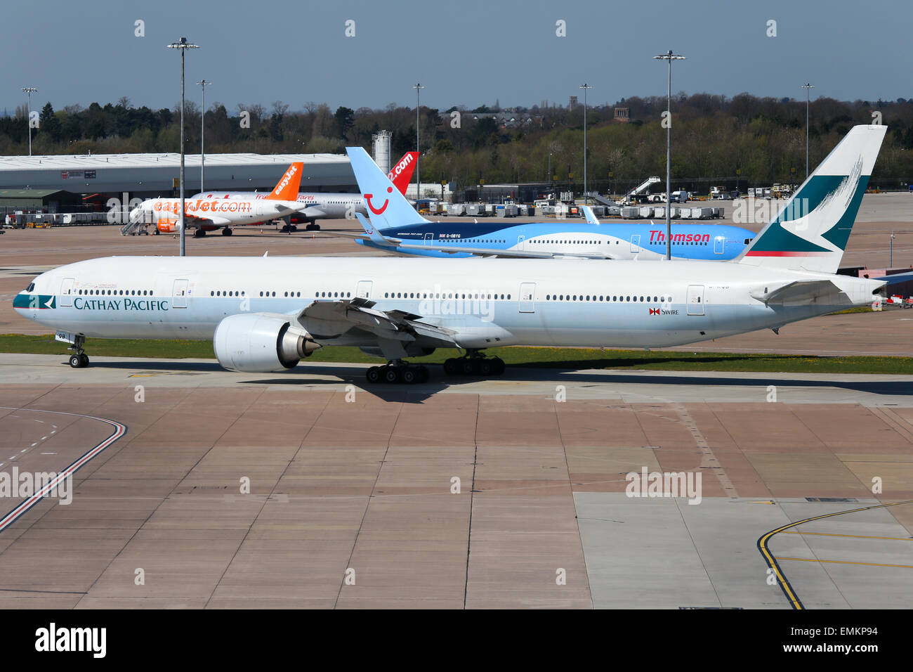 Cathay Pacific Boeing 777-300 taxis to the active runway at Manchester airport. Stock Photo