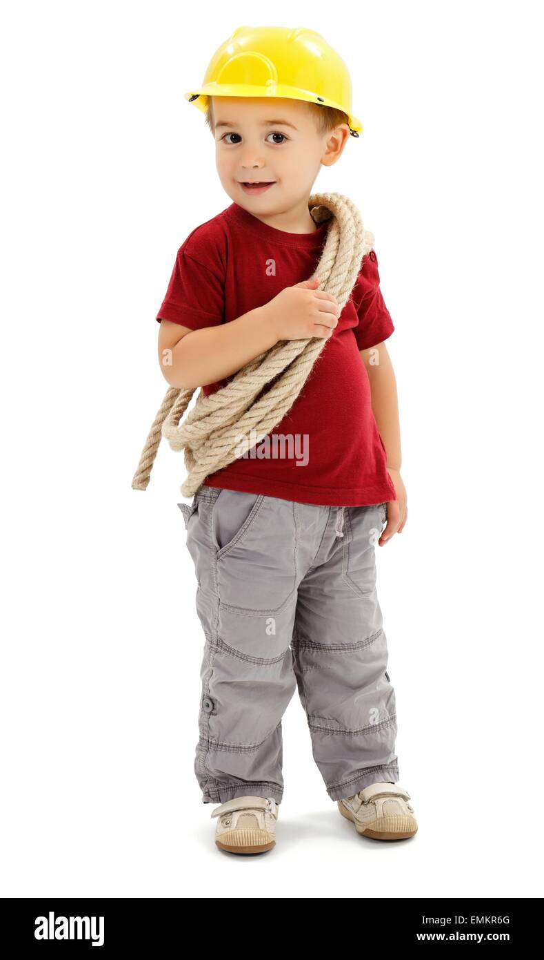 Little boy playing handyman, holding rope and wearing yellow protective helmet, imitating builder Stock Photo