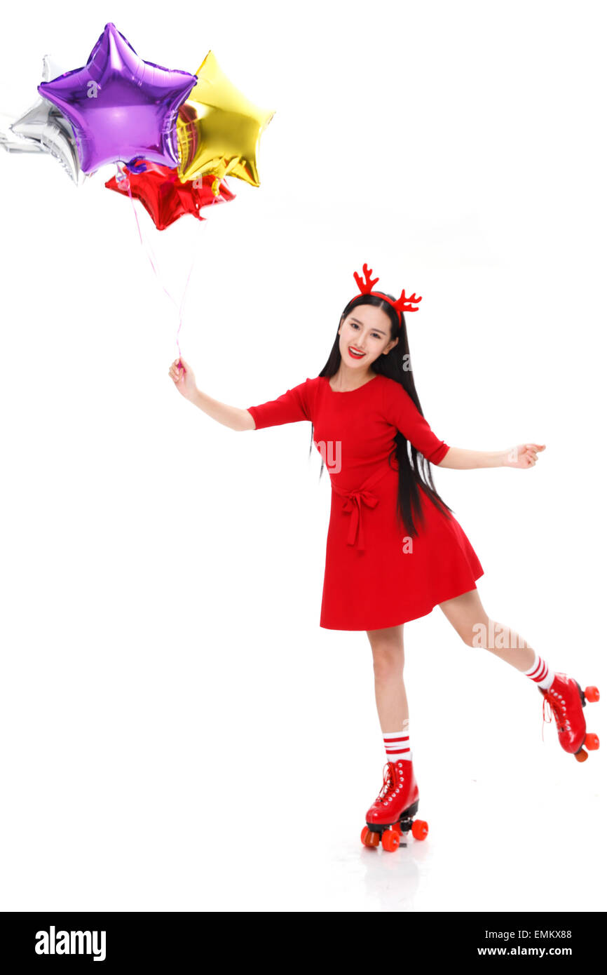 A young woman with a balloon in the roller skating Stock Photo