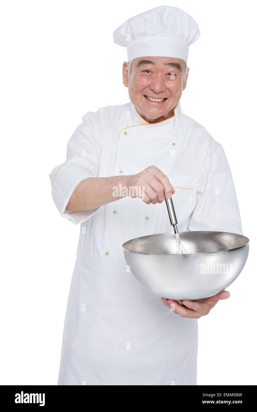 An elderly man wearing a chef's kitchen utensils and appliances Stock
