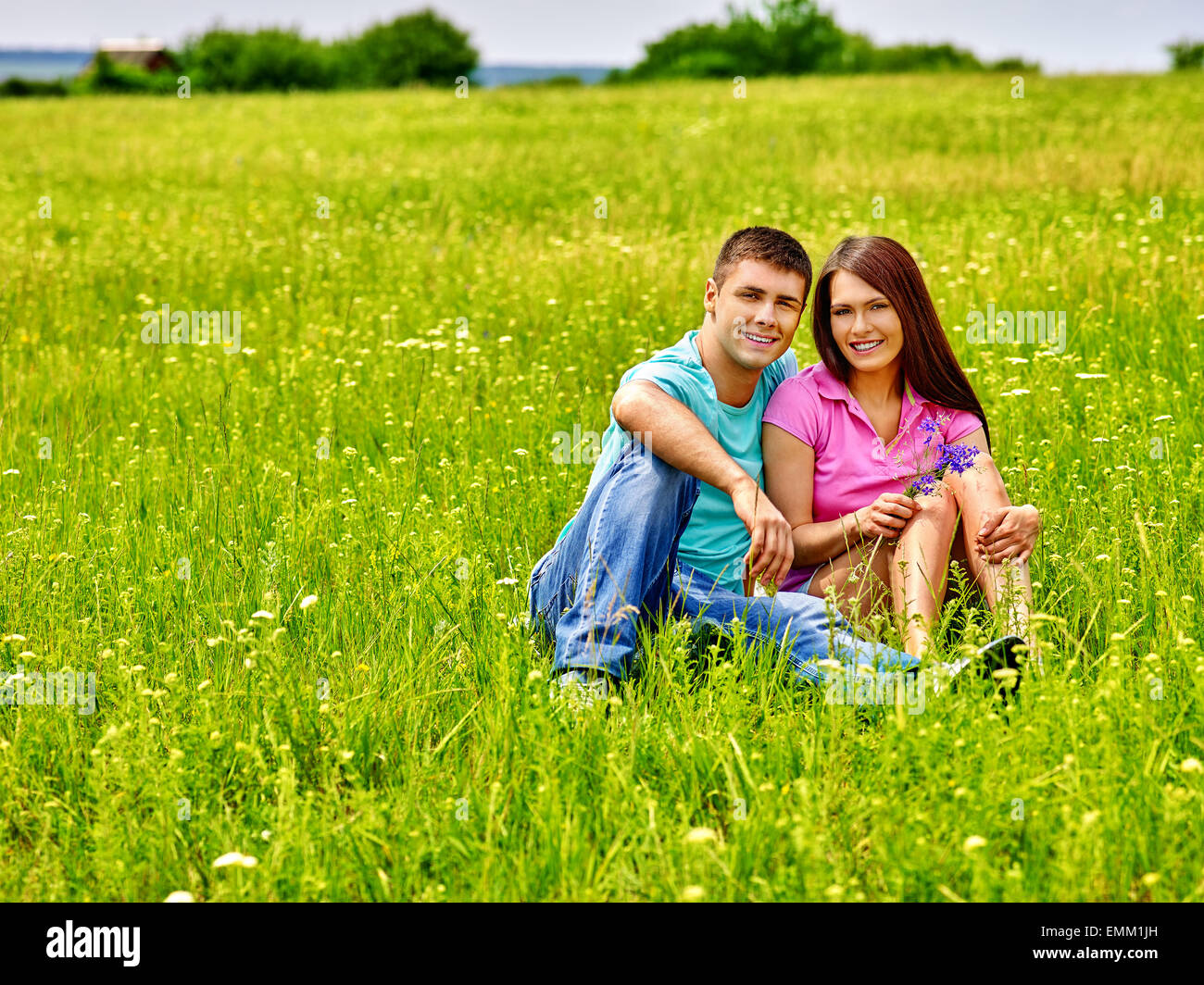 Couple on green grass Stock Photo - Alamy