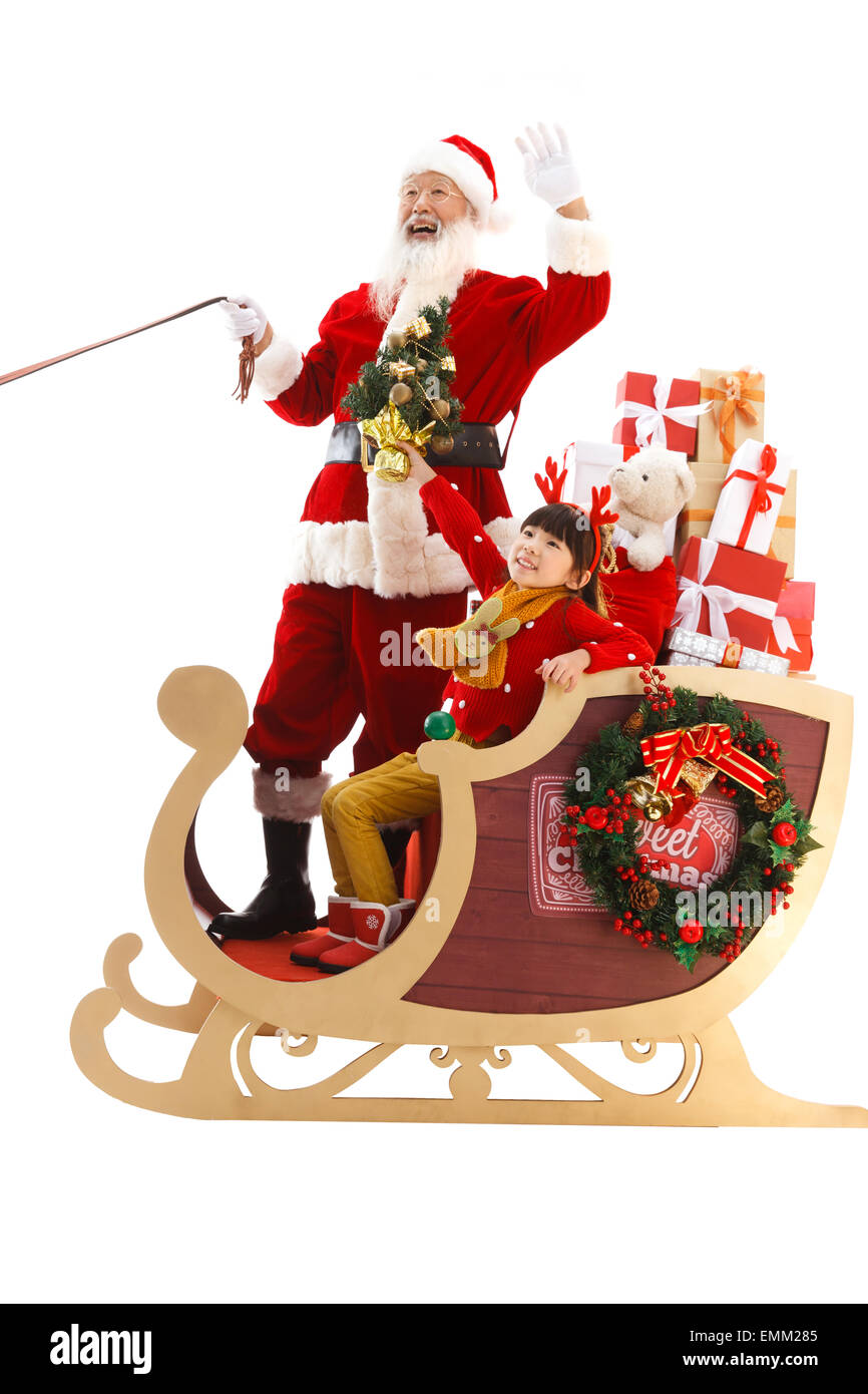 Santa and the little girl in the sleigh Stock Photo