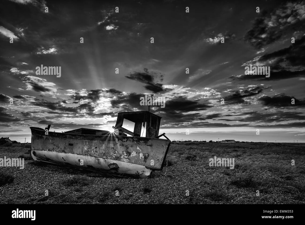 Abandoned fishing boat on shingle beach black and white landscape at ...