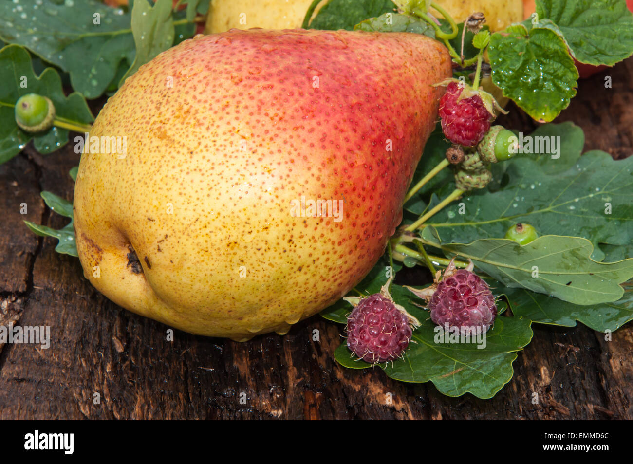 Ripe pear and berry raspberry on wood countertop Stock Photo - Alamy