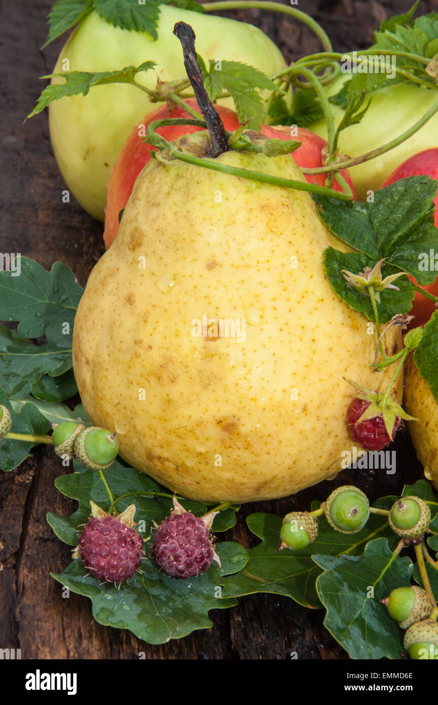 Ripe pear and berry raspberry on wood countertop Stock Photo - Alamy