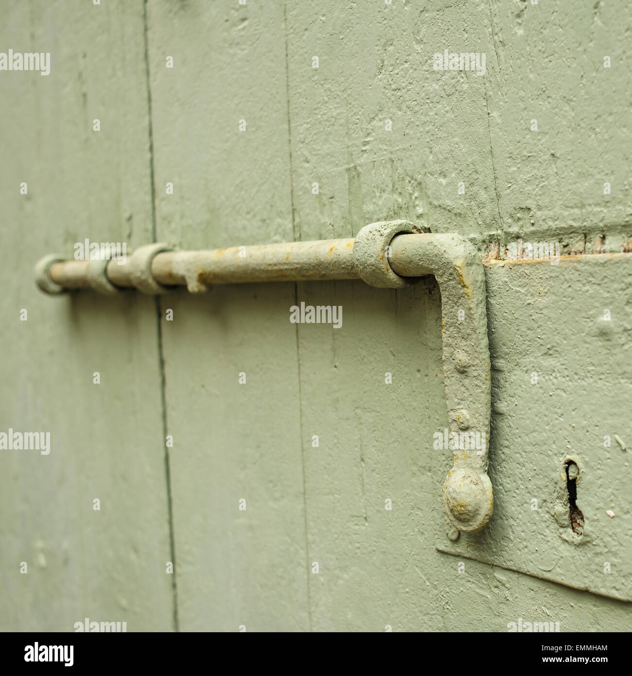 Old latch of a wooden door of a cow shed Stock Photo
