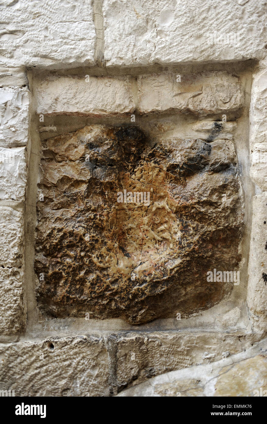 Israel. Jerusalem. Old City. Old City. V Station. Place of encounter between Jesus and Simon of Cyrene, the man who carried the cross of Christ to Mount Calvary. Detail of the stone from 1st century, where it's said that Jesus left the print of his hand. Stock Photo