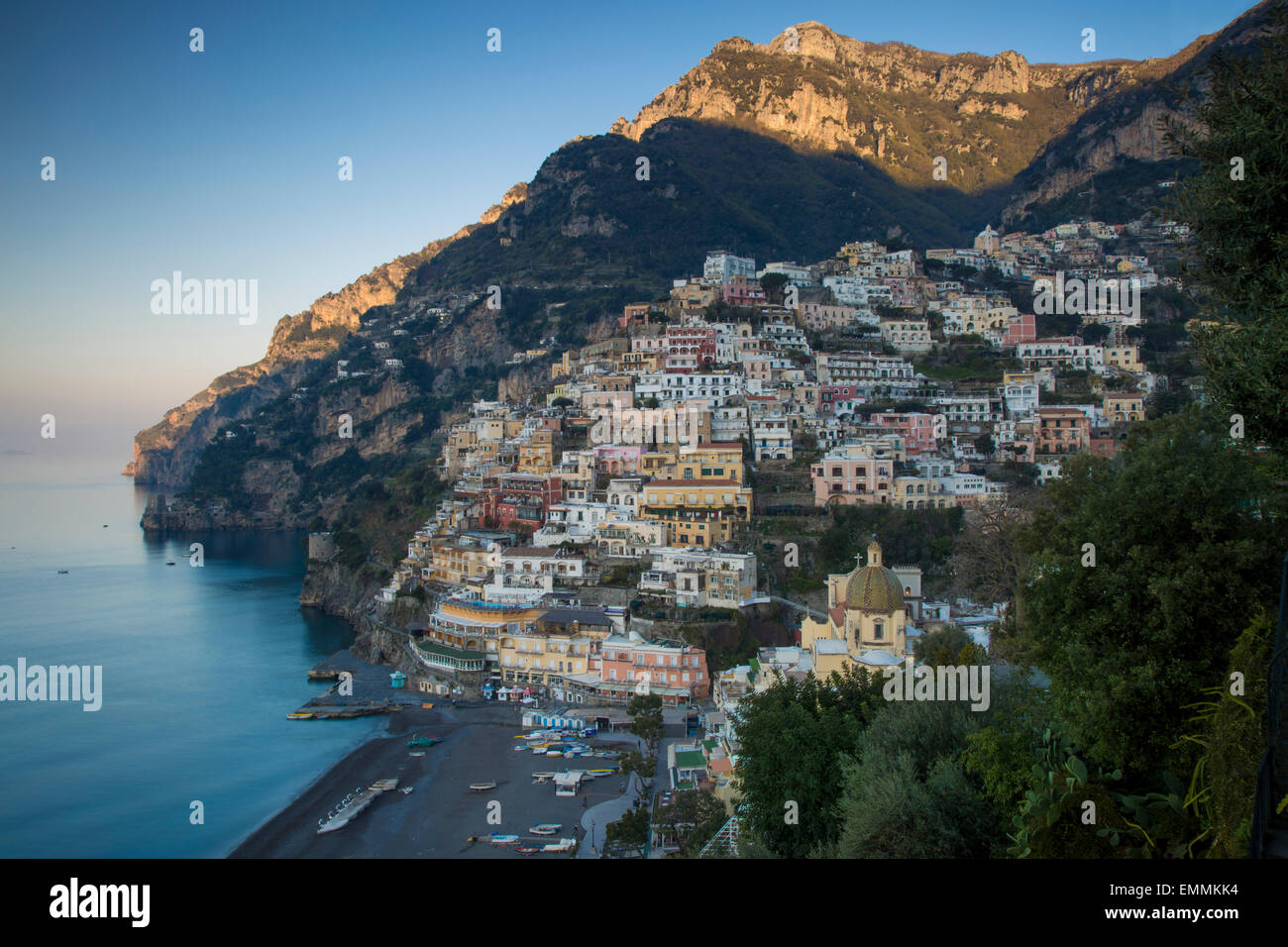 Early morning sunlight first touching the mountains above Positano along the Amalfi Coast, Campania, Italy Stock Photo