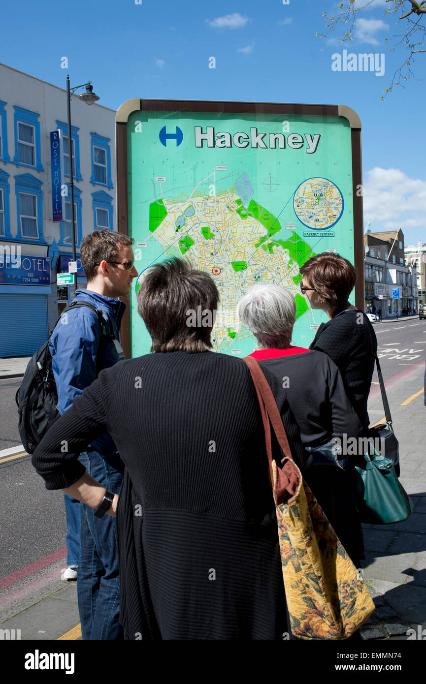 Hackney, London. Stoke Newington High Street. People looking at a public map. Stock Photo