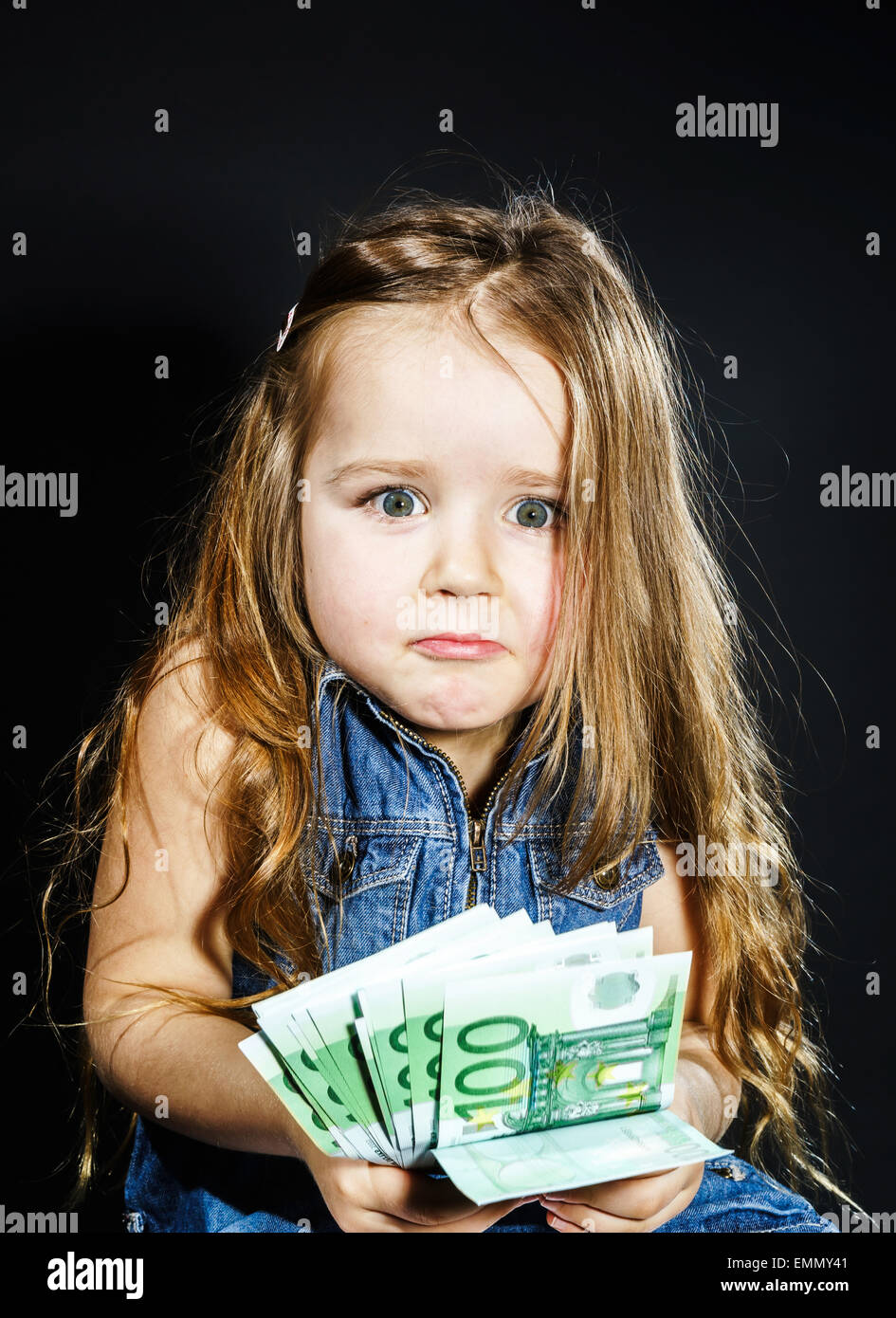 Cute little girl with money euro in her hand. Business concept. How