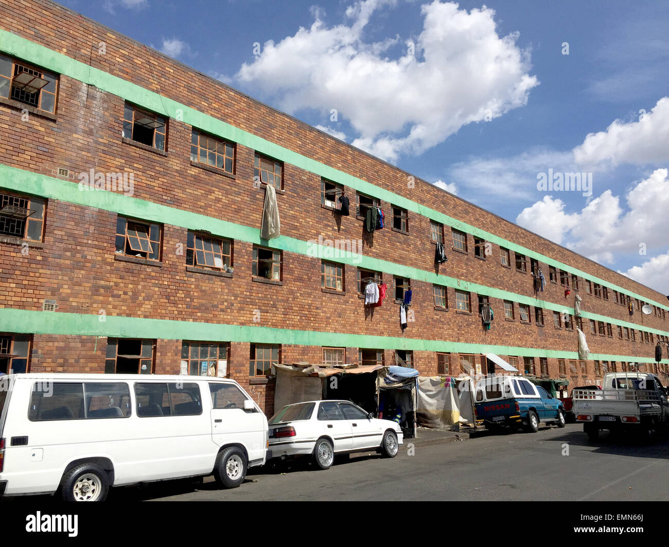 Johannesburg, South Africa. 21st Apr, 2015. Cars parked in front of the Jeppestown workers' home in the center of Johannesburg, South Africa, 21 April 2015. The 1,500-resident home, originally founded for mine workers, was one of the starting points for the xenophobic riots of the past weeks. Dozens of immigrant-owned shops were looted. Photo: JUERGEN BAETZ/dpa/Alamy Live News Stock Photo