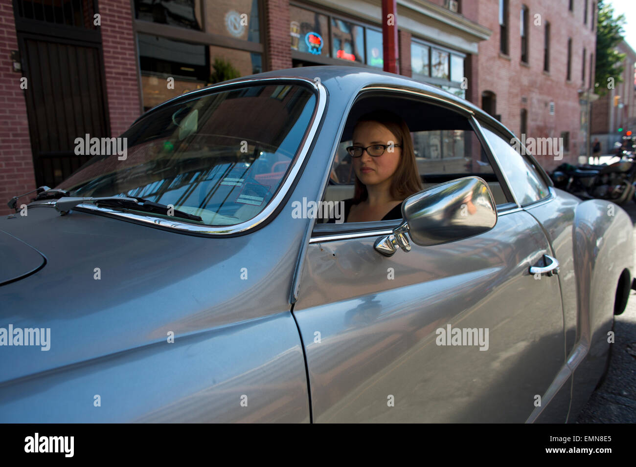 a Canadian girl driving an old VW sports car Stock Photo