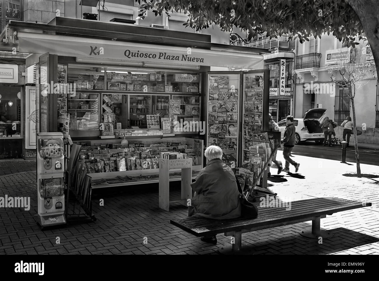 -Woman resting in a bench in a square in Alicante City- Spain. Stock Photo