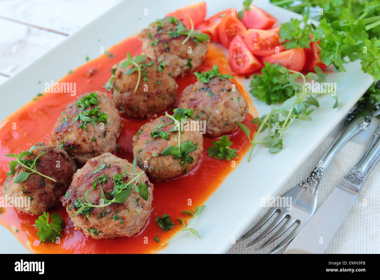 Meatballs with fresh herbs in tomato sauce Stock Photo