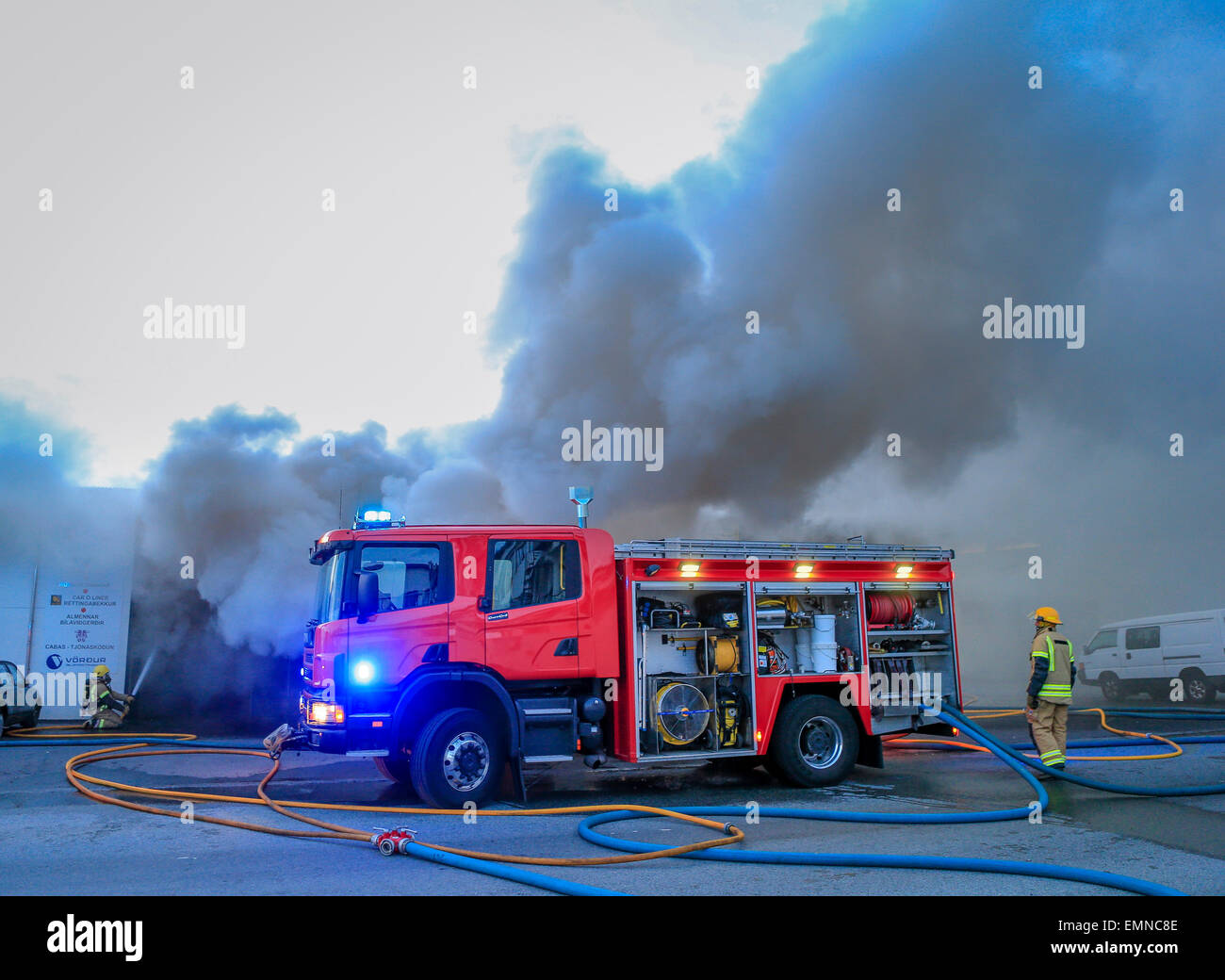 Firemen at the scene of a fire involving a small business. Kopavogur, Iceland Stock Photo