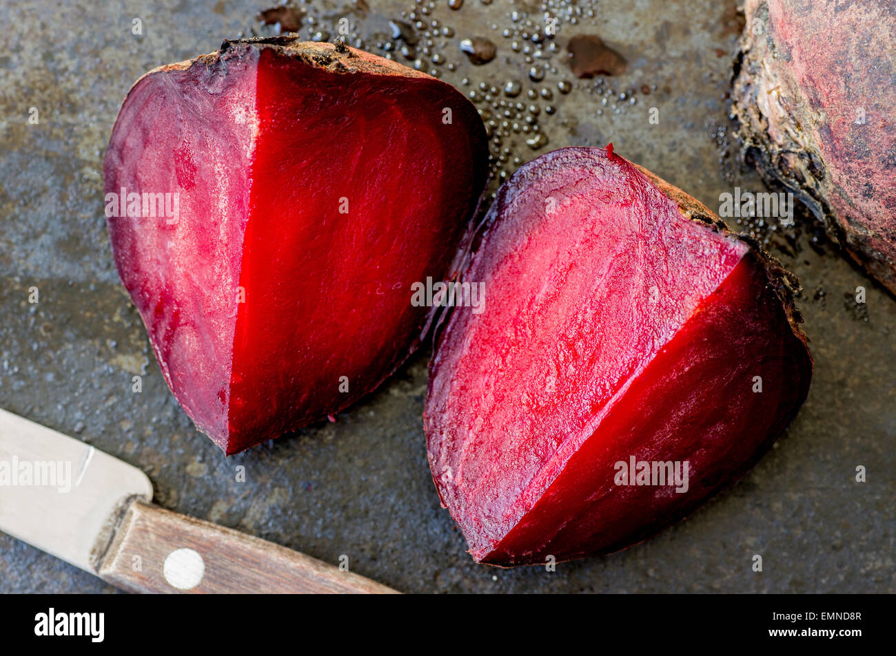 Slices of boiled beets and knife top view Stock Photo