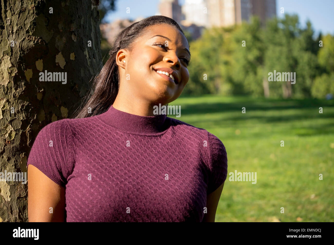 Smiling black woman in purple hi-res stock photography and images - Alamy