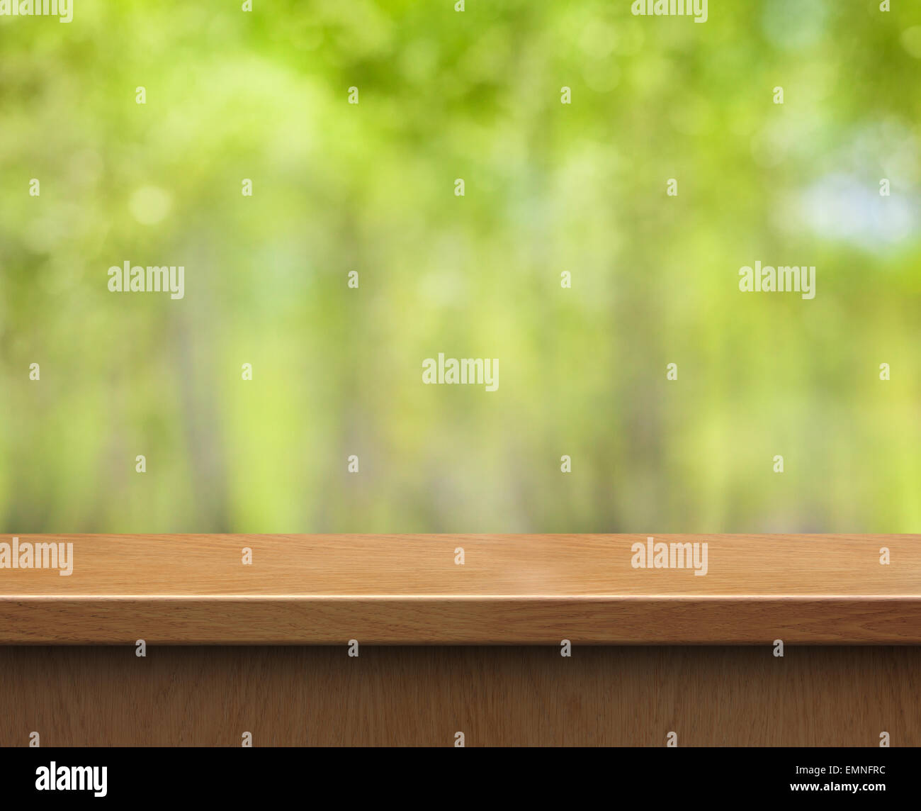 empty wood table for product display on green blurred background Stock Photo