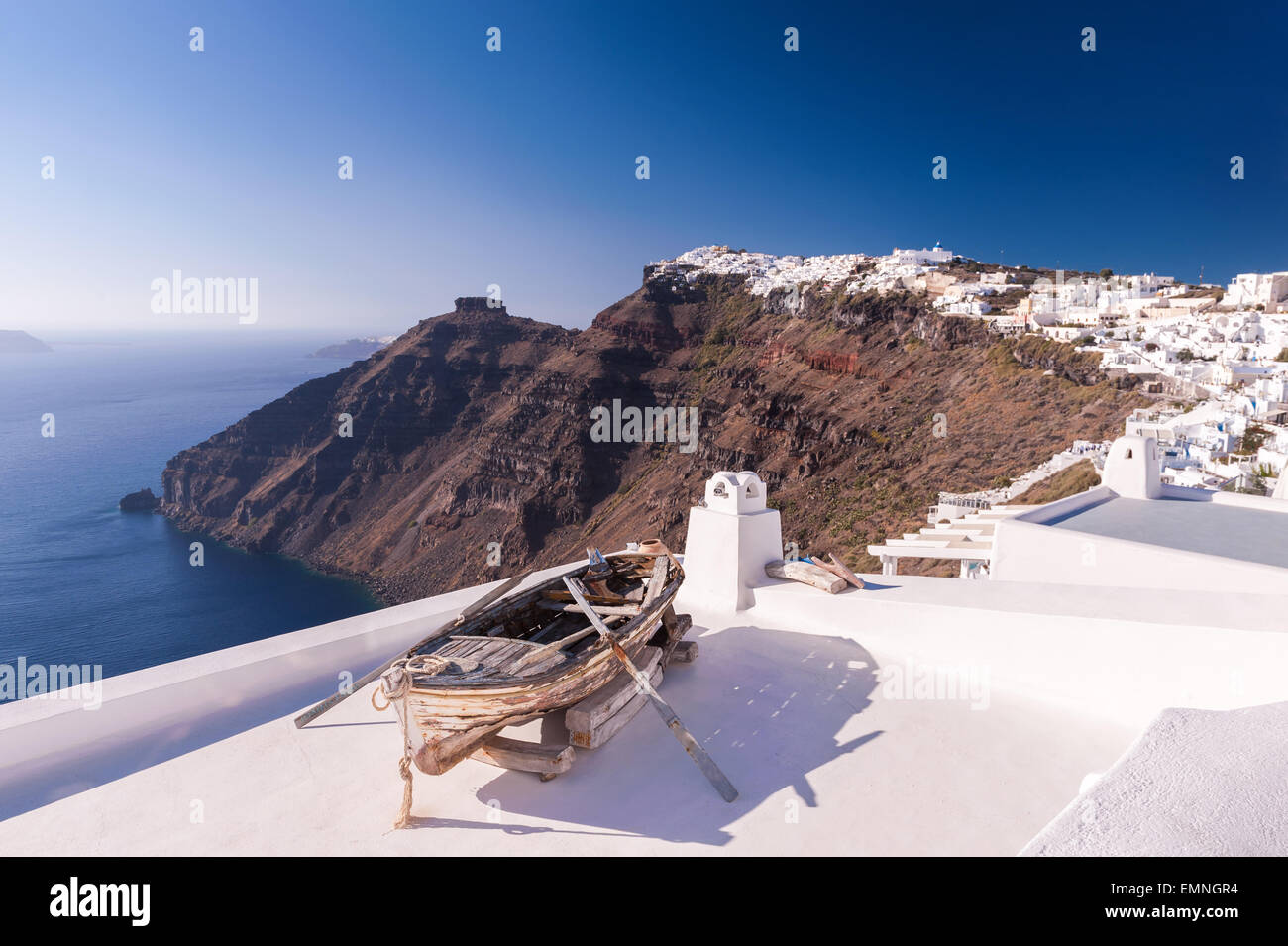 Old wooden rowing boat placed on a roof of one of houses in Fira, Santorini island, Greece Stock Photo