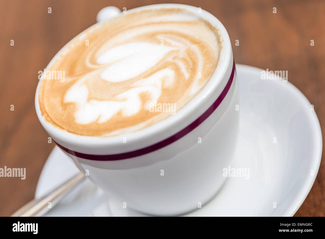 White Cup Of Coffee With Heart Pattern On Wooden Table Stock Photo
