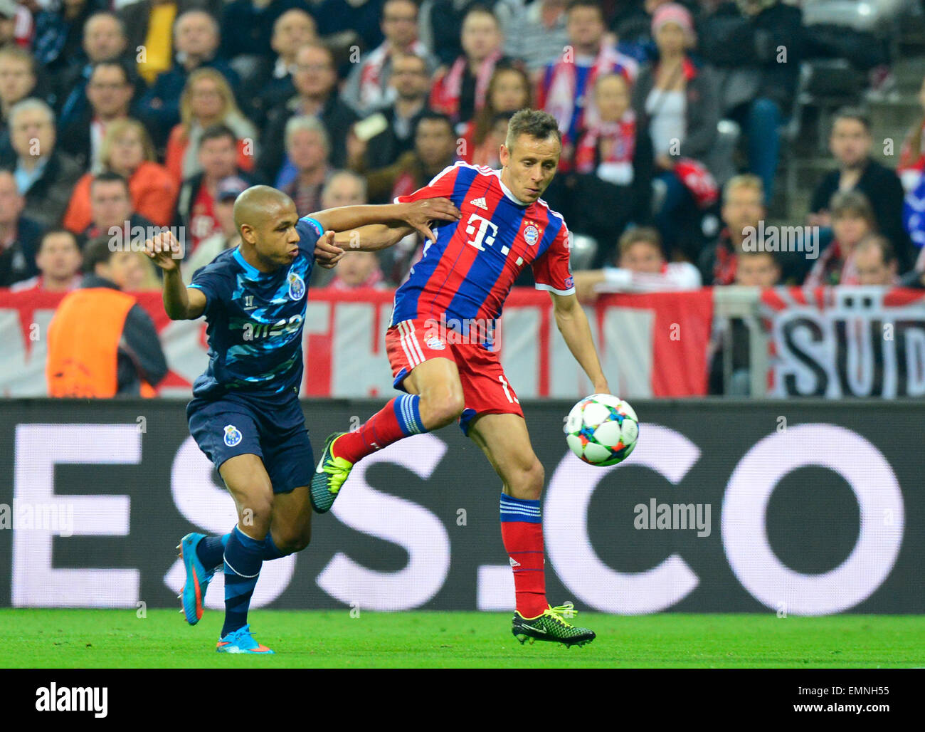 Munich's Rafinha (r) and Porto's Yacine Brahimi (l) compete for the ball during the Champions League quarter finals second leg soccer match between FC Bayern Munich and FC Porto in the Arena in Munich, Germany, 21 April 2015. Bayern Munich won 6-1. Photo: Marc Mueller/dpa Stock Photo