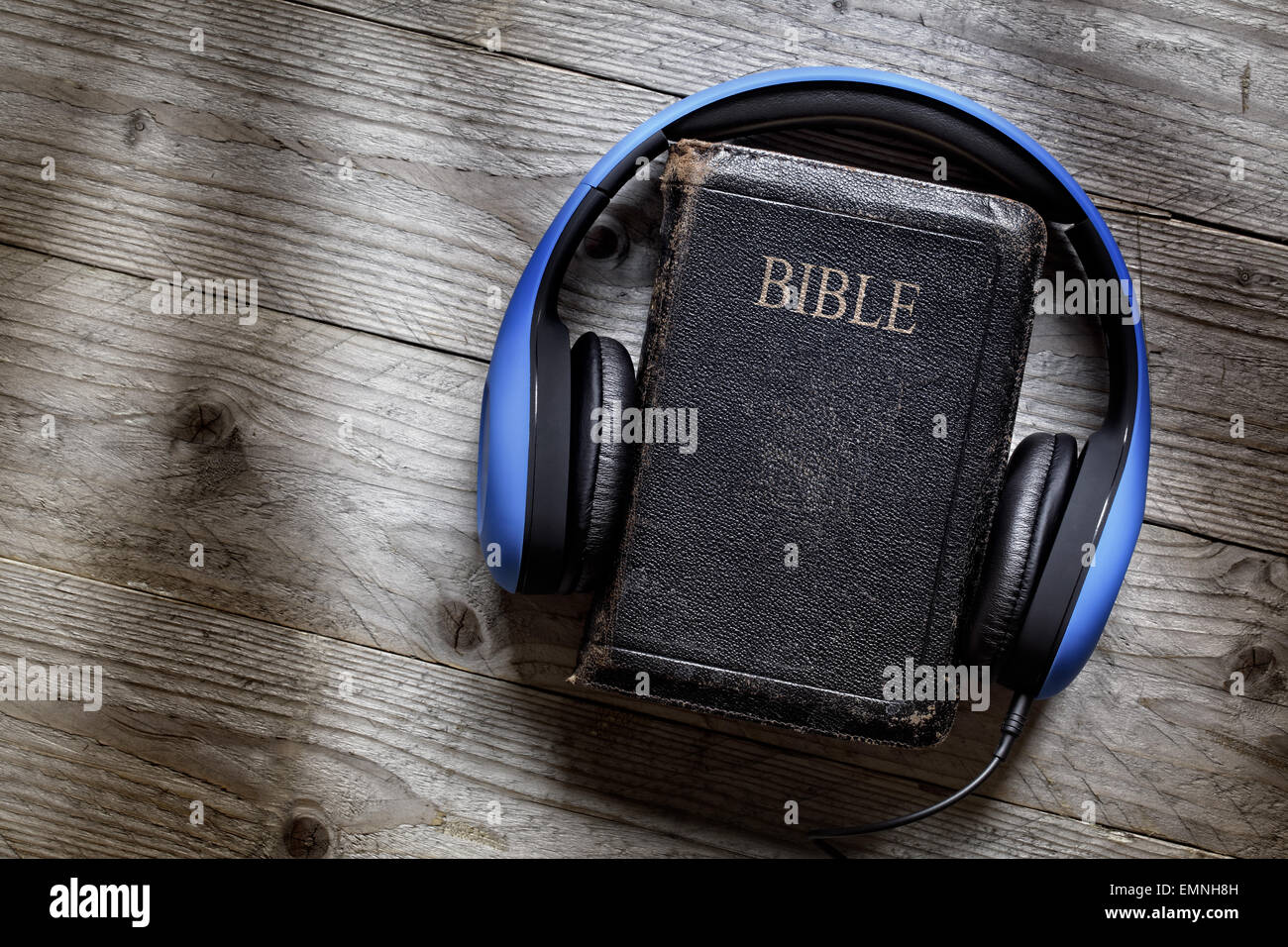 Holy Bible and headphones concept for modern religious education, podcast or help with hearing for blind studying Stock Photo
