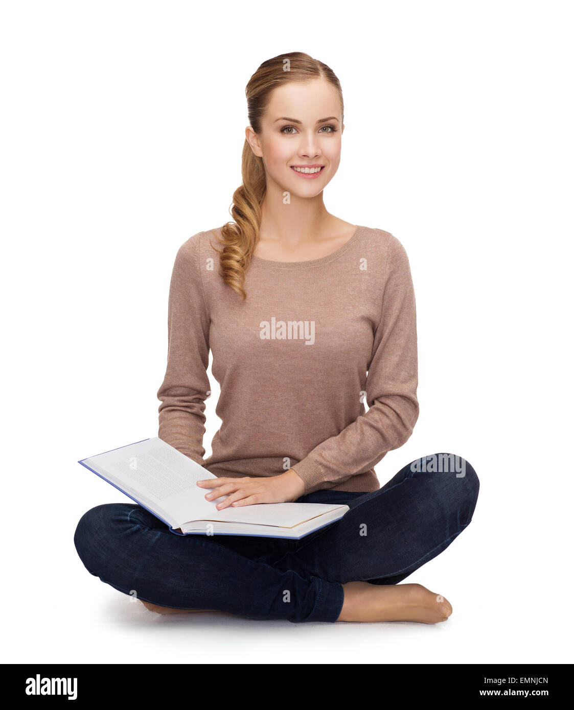 smiling young woman sitting on floor Stock Photo - Alamy