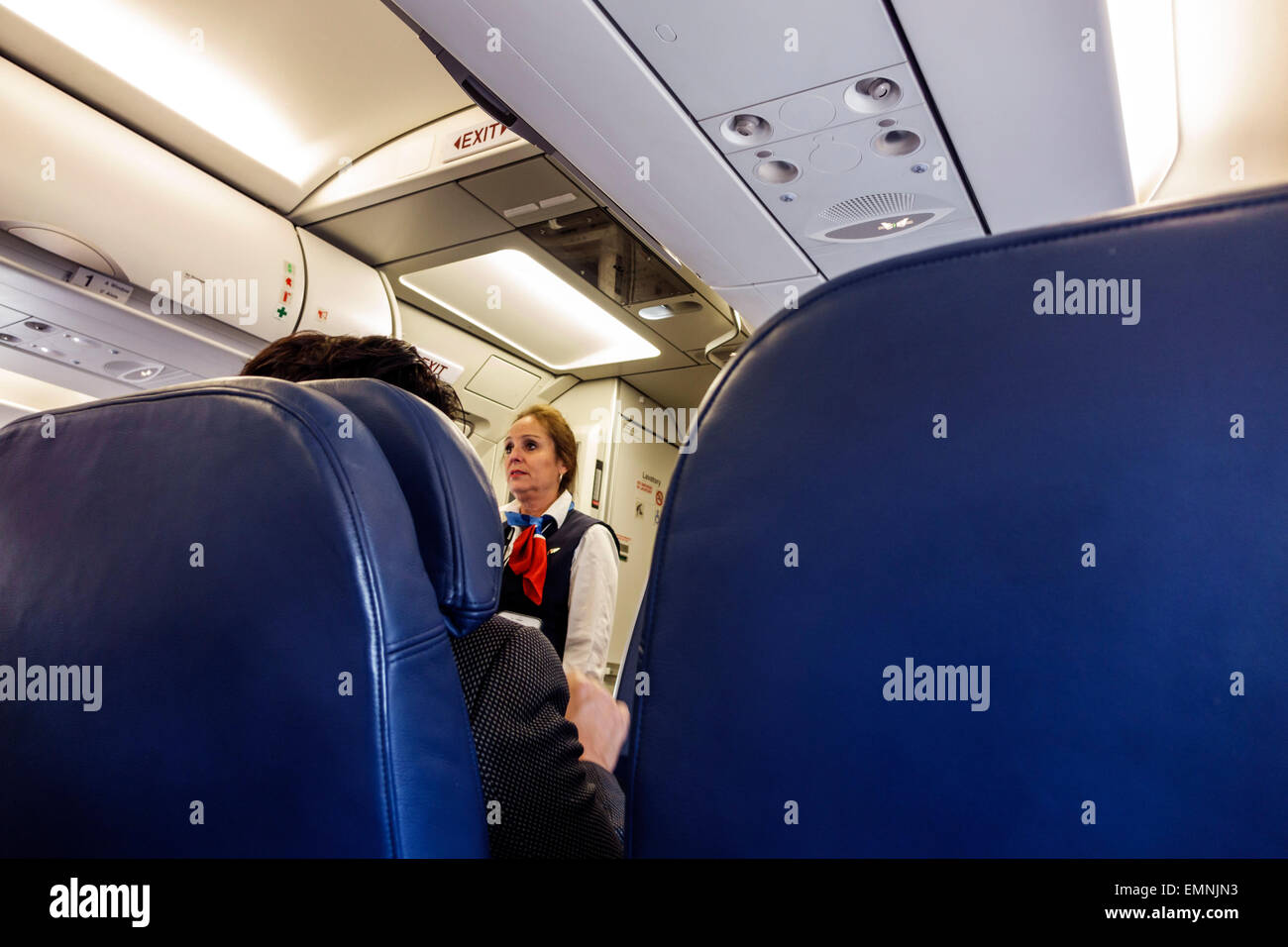 Miami Florida International Airport MIA,onboard,cabin,US Airways,flight to Charlotte,adult adults woman women female lady,flight attendant,safety inst Stock Photo