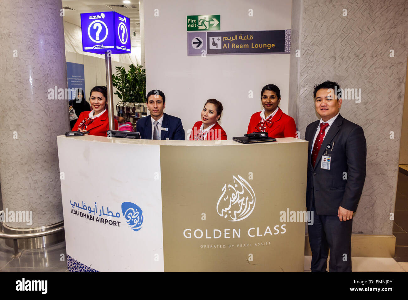 Abu Dhabi United Arab Emirates UAE,International Airport,AUH,terminal,gate,interior inside,information,desk,help,Arabic English,Golden Class,Asian man Stock Photo
