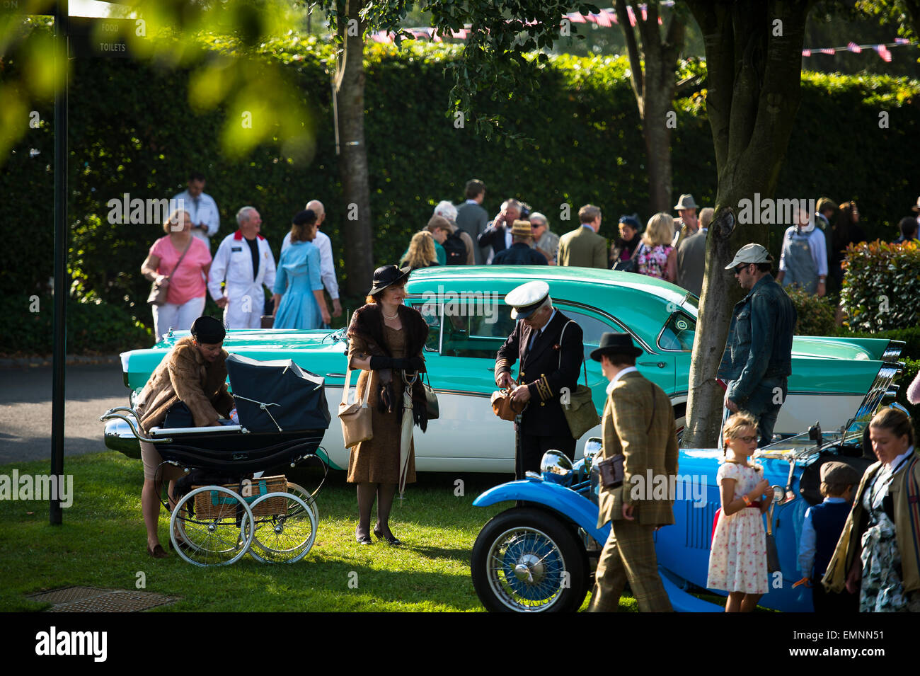 CHICHESTER, ENGLAND - September 12-14, 2014: Historic automobile racing festivities on and off the track for the Goodwood Revival. The Revival celebrates the golden age of motorsport at the Goodwood Motor Circuit, from 1948 to 1966. Stock Photo