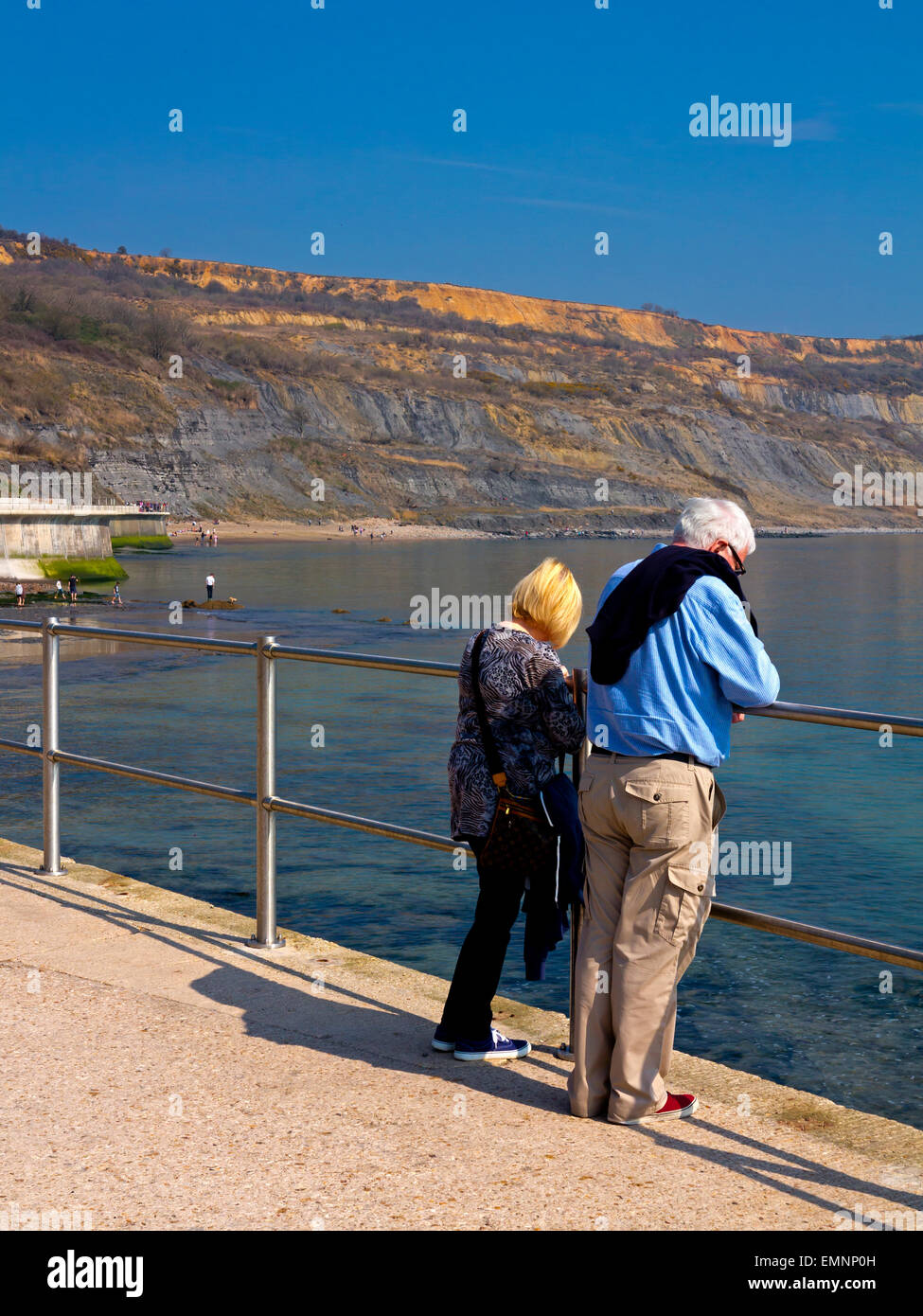 Tourists on the East Cliff coastal wall and sea defences at Lyme Regis Dorset England UK built 2014 to prevent coastal erosion Stock Photo
