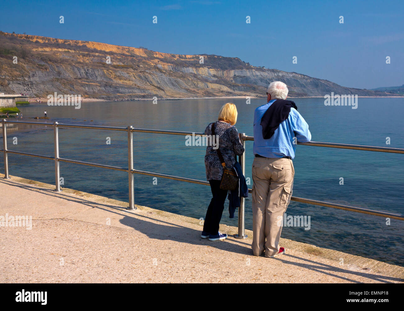 Tourists on the East Cliff coastal wall and sea defences at Lyme Regis Dorset England UK built 2014 to prevent coastal erosion Stock Photo