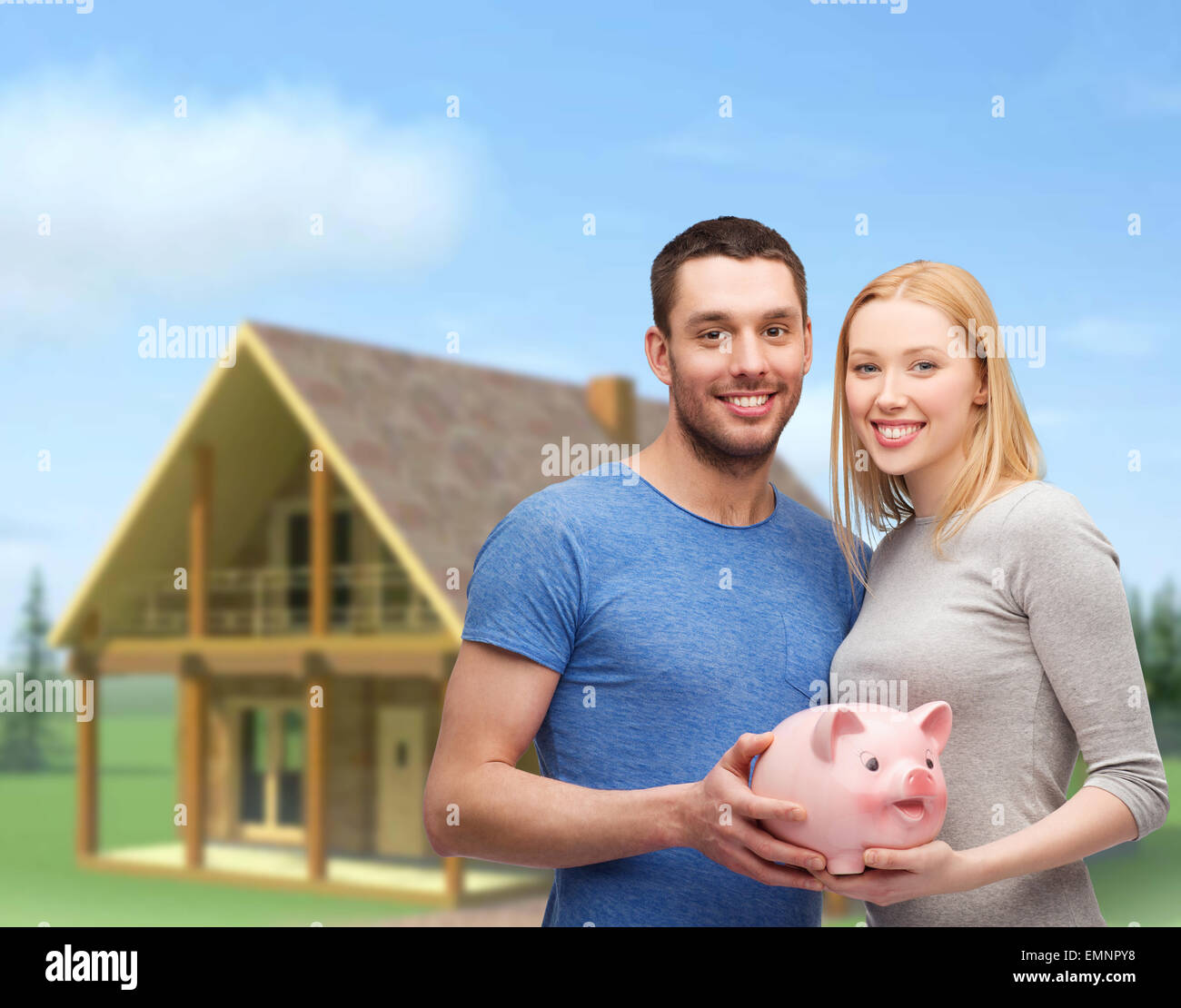 smiling couple holding big piggy bank Stock Photo - Alamy