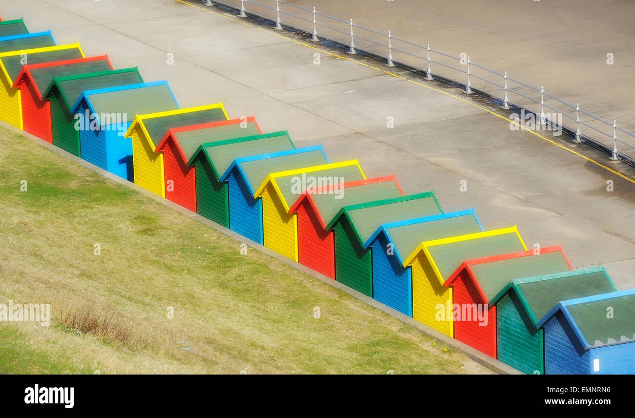 Brightly coloured beach huts on the sea front in Whitby ,North Yorkshire, England,uk Stock Photo