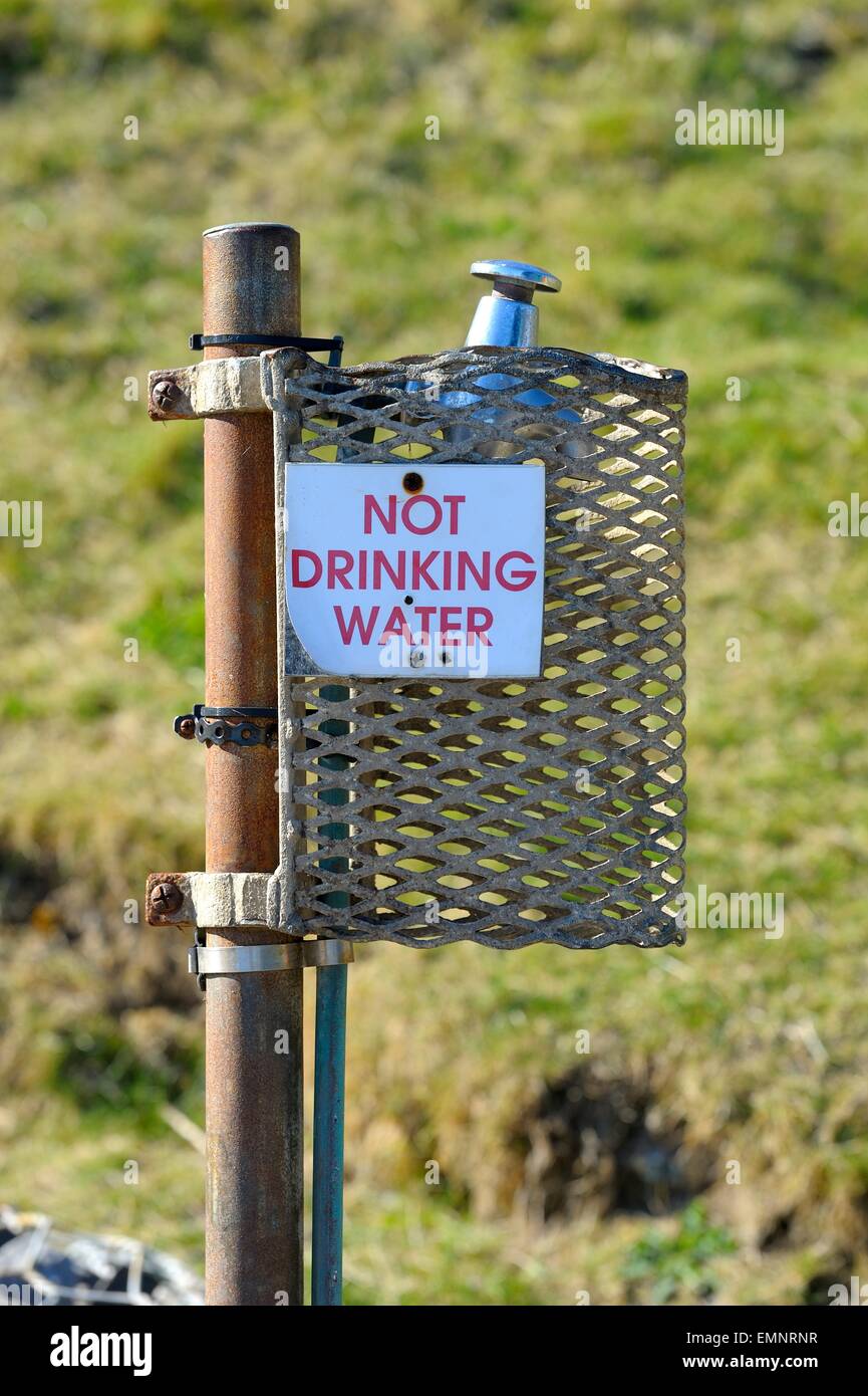 An outside tap with a not drinking water sign on Stock Photo