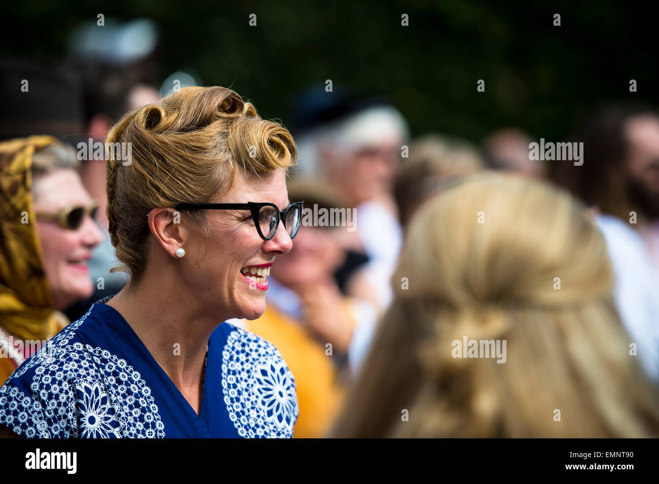CHICHESTER, ENGLAND - September 12-14, 2014: Historic automobile racing festivities on and off the track for the Goodwood Revival. The Revival celebrates the golden age of motorsport at the Goodwood Motor Circuit, from 1948 to 1966. Stock Photo