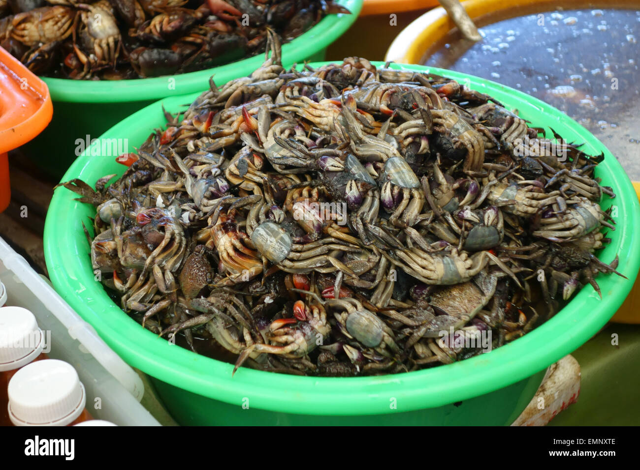 Small dead crabs for sale on a stall in a Bangkok food market Stock Photo