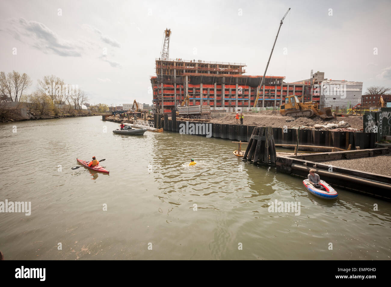 New York, USA. 22nd Apr, 2015. Donning his protective wetsuit, clean water activist Christopher Swain swims in the fetid waters of the polluted Gownus Canal in Brooklyn in New York on Earth Day, April 22, 2015. Swain's swim, swimming about a third of the canal, was to call attention for an accelerated cleanup of the waterway. The Gowanus Canal, which was completed in the late 1860's to facilitate industry along it's banks, became increasingly polluted until a pumping station was constructed at one end in the early 20th century to 'flush' out the canal. Credit:  Richard Levine/Alamy Live News Stock Photo