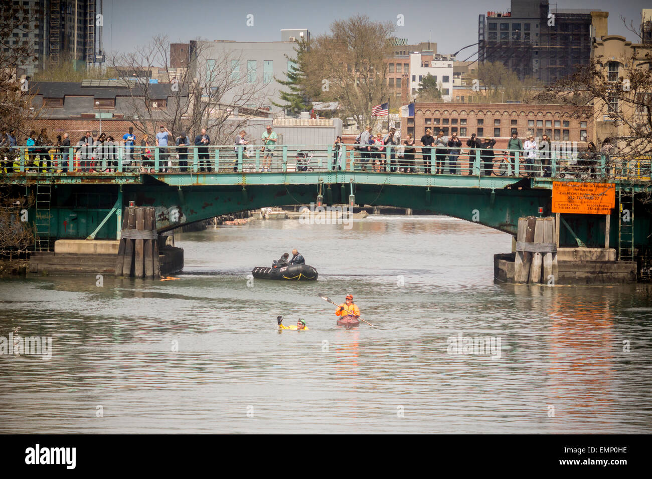 New York, USA. 22nd Apr, 2015. Donning his protective wetsuit, clean water activist Christopher Swain swims in the fetid waters of the polluted Gownus Canal in Brooklyn in New York on Earth Day, April 22, 2015. Swain's swim, swimming about a third of the canal, was to call attention for an accelerated cleanup of the waterway. The Gowanus Canal, which was completed in the late 1860's to facilitate industry along it's banks, became increasingly polluted until a pumping station was constructed at one end in the early 20th century to 'flush' out the canal. Credit:  Richard Levine/Alamy Live News Stock Photo