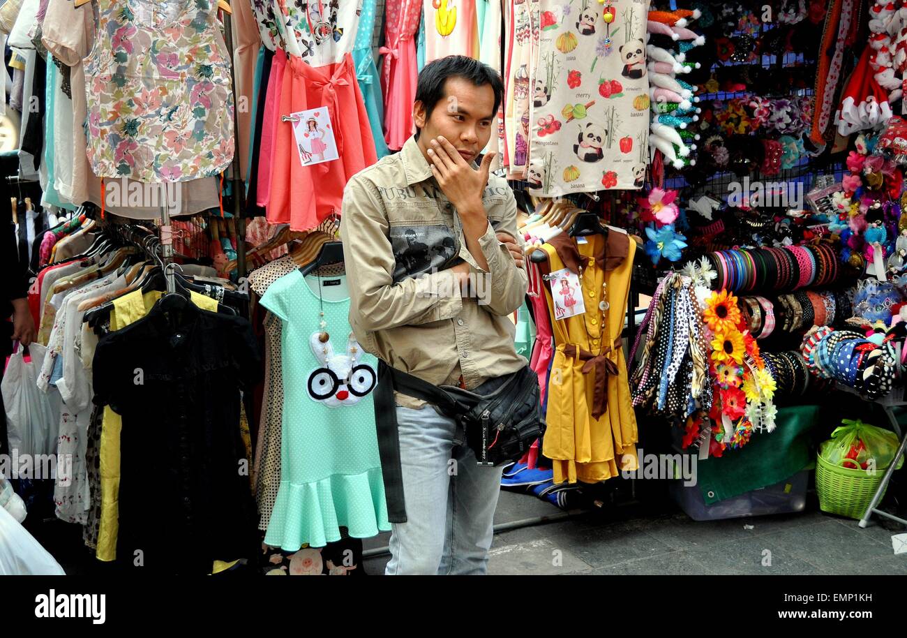 Bangkok, Thailand:  Vendor in a pensive mood at his outdoor women's clothing stand on Thanon Ratchaprasong Stock Photo