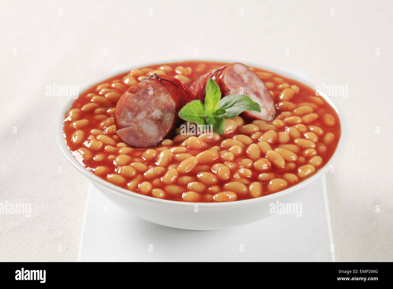 Baked beans and sausage in a white bowl Stock Photo Alamy