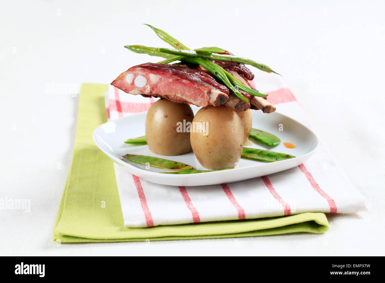 Pork ribs with potatoes, string beans and snow peas Stock Photo Alamy