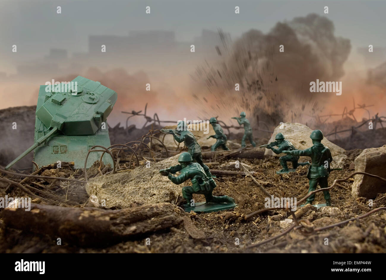 Toy war field. Plastic toy attack war scene with soldiers, weapons and explosions. Stock Photo