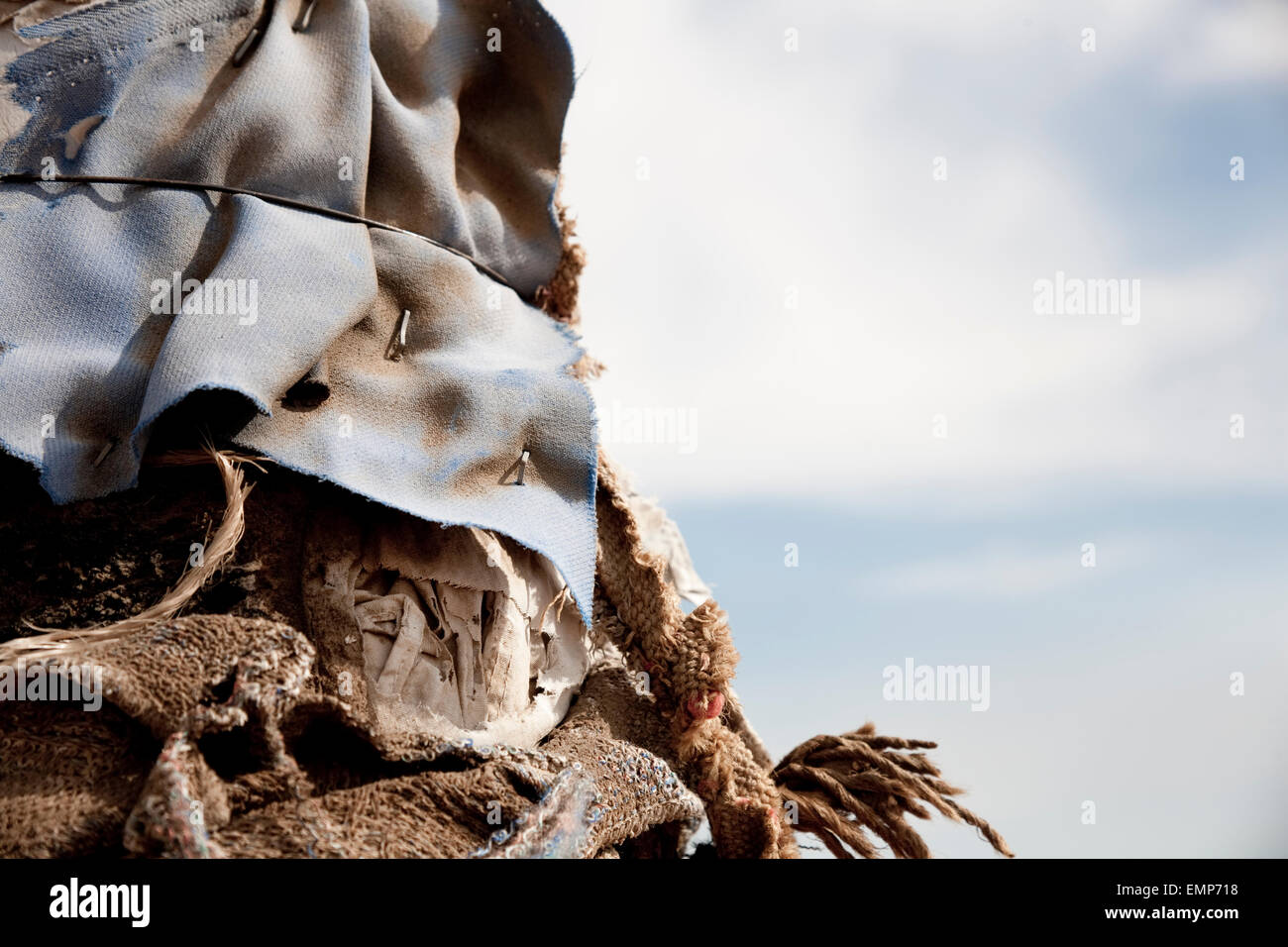 Detail of a pole in the desert near Joshua Tree, California, wrapped in torn and textured fabric. Stock Photo