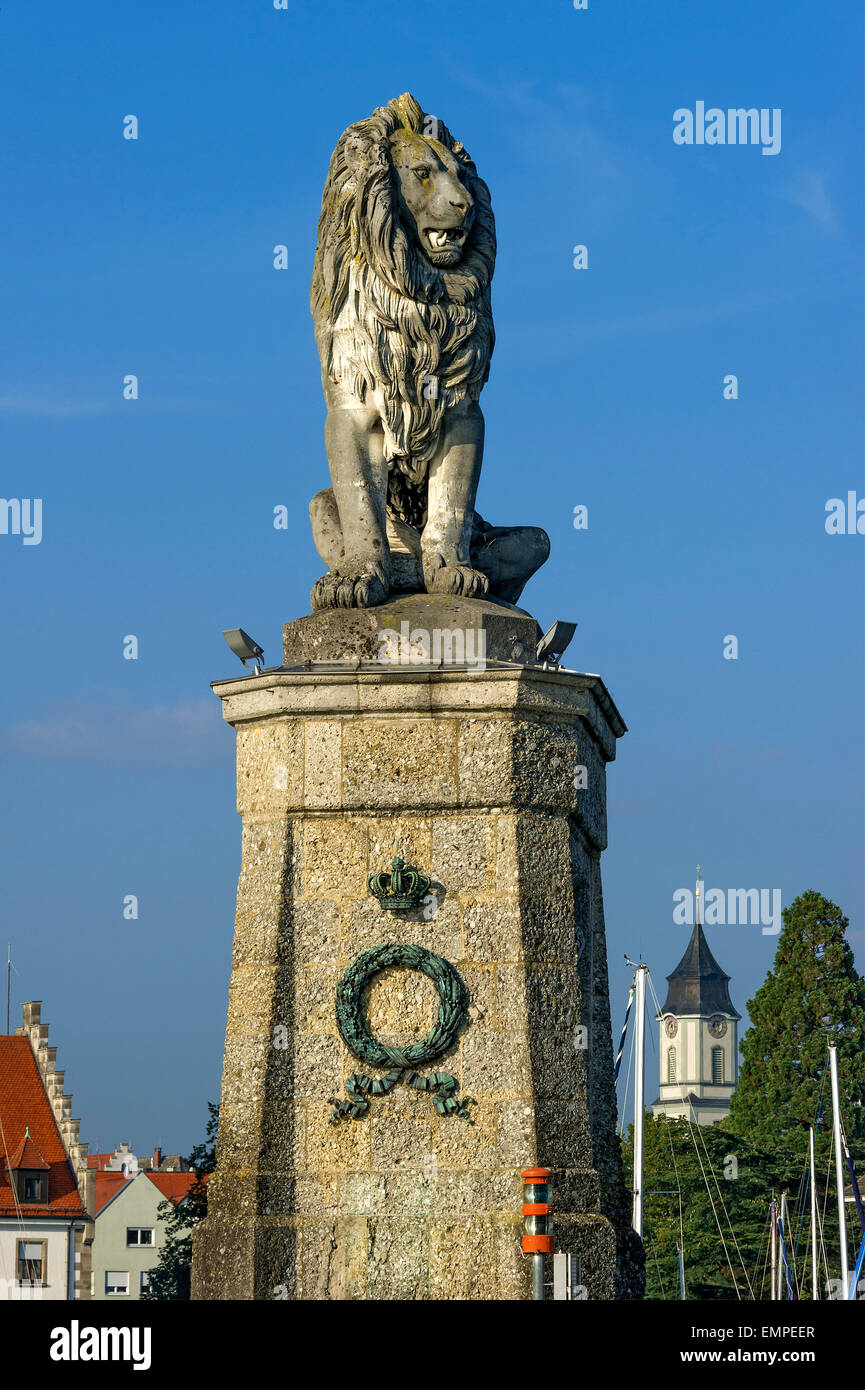 Bavarian Lion at the port entrance, Notre-Dame Cathedral behind, port, Lake Constance, Lindau, Swabia, Bavaria, Germany Stock Photo