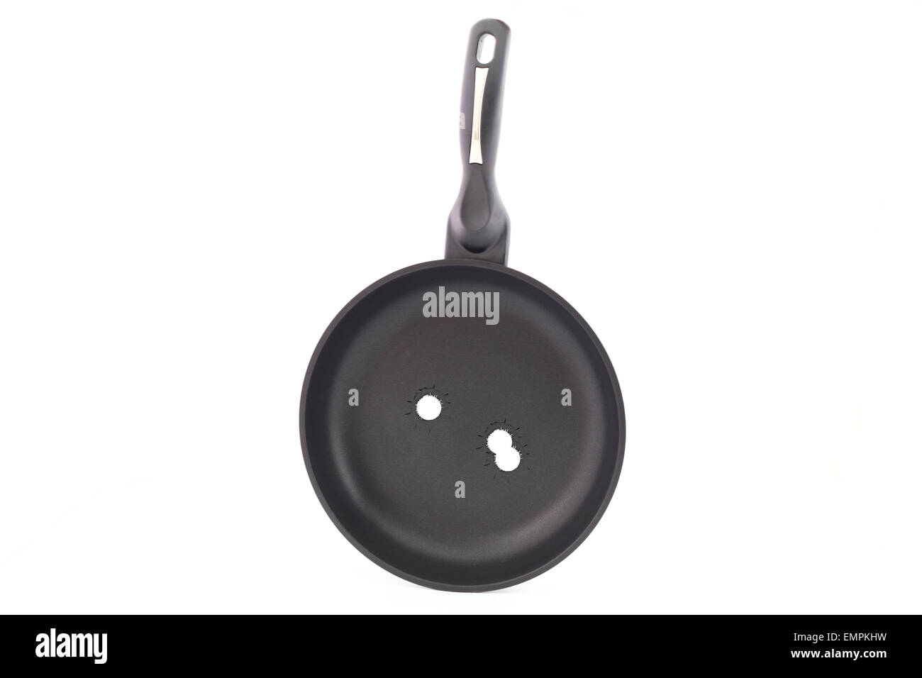 Frying pan on a white background with bullet holes Stock Photo
