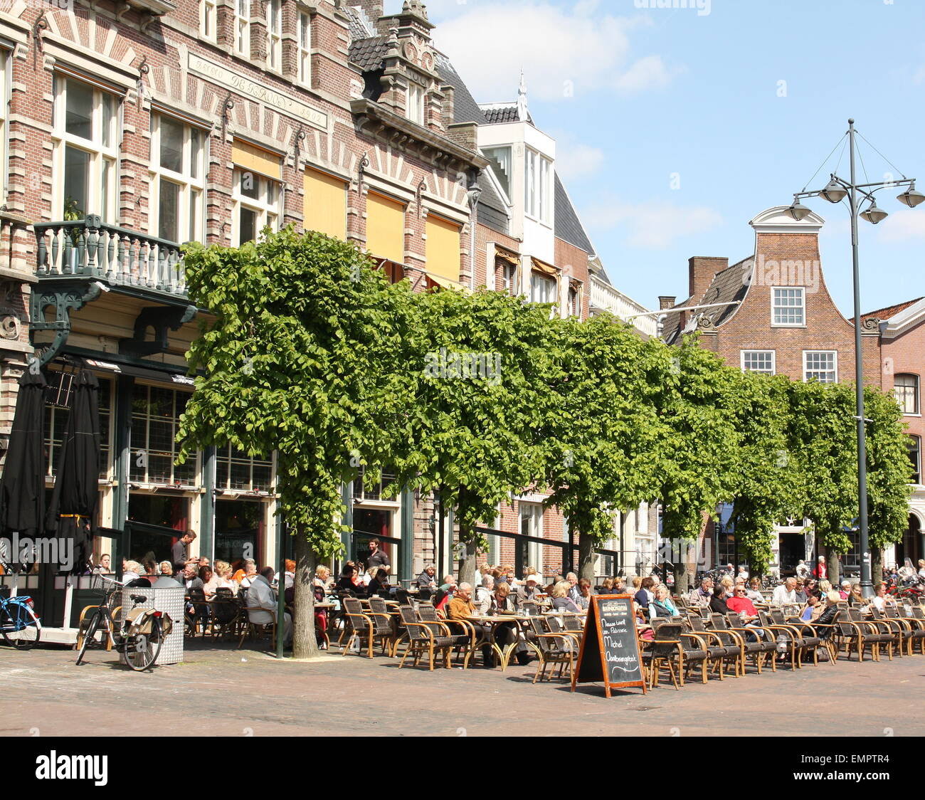 People sitting on a terrace in the center of Haarlem. Netherlands Stock Photo