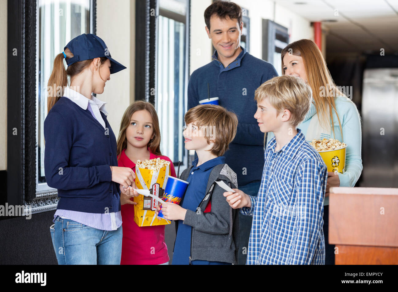 Worker Checking Tickets Of Family At Cinema Stock Photo Alamy