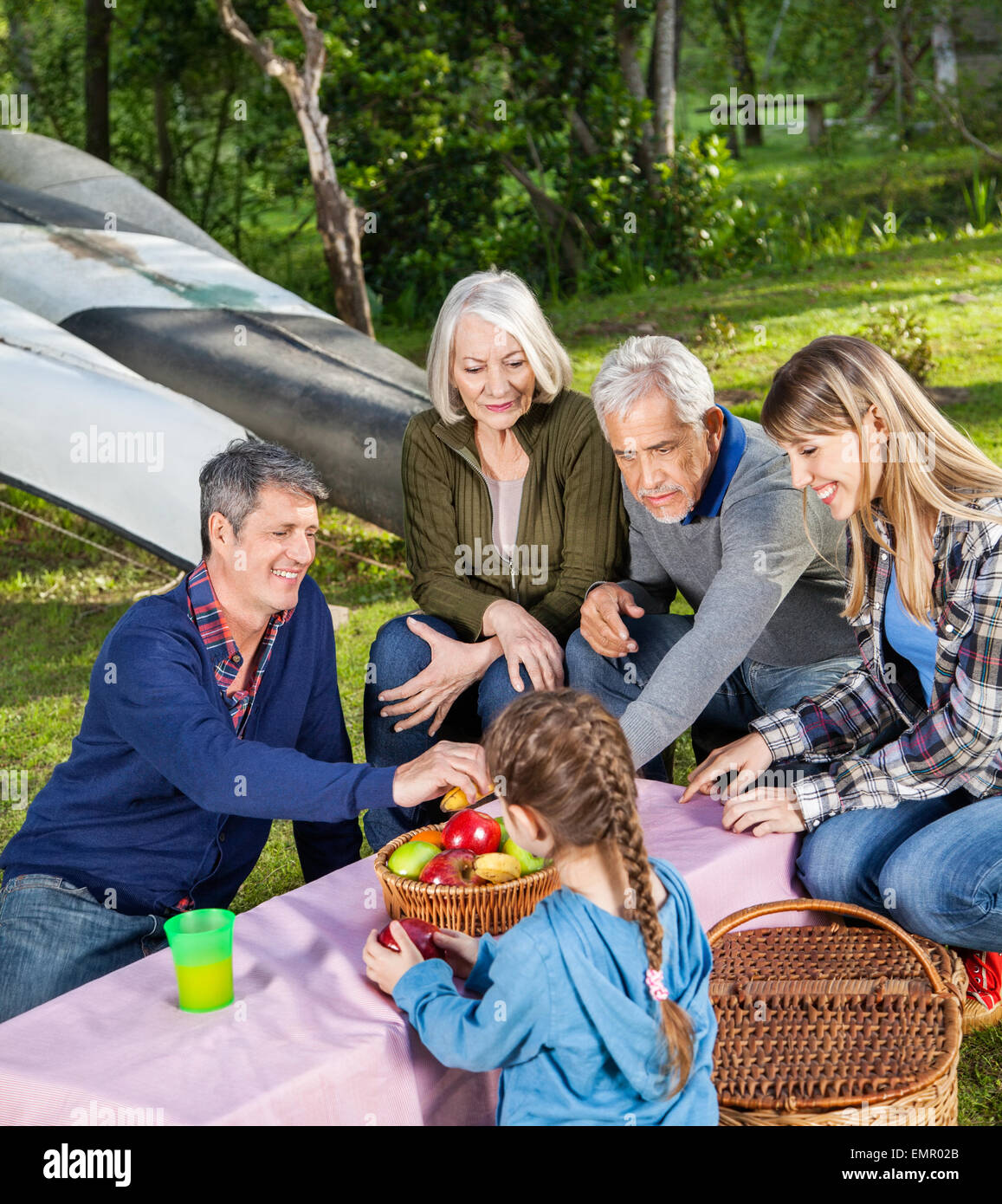 Family Having Fruits At Campsite Stock Photo