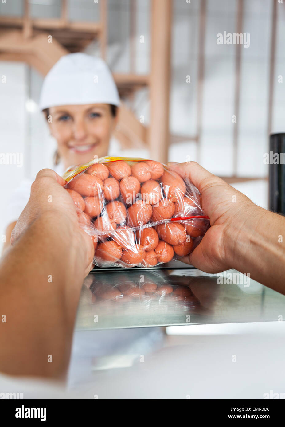 Butcher Selling Packed Sausages To Customer Stock Photo Alamy